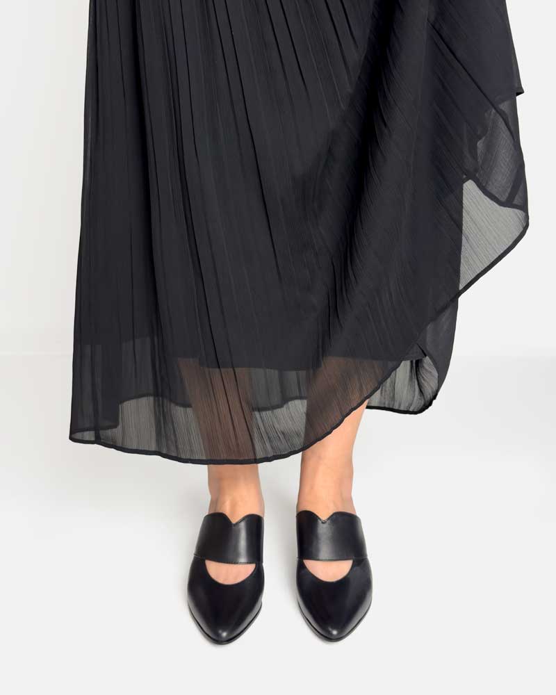 model wearing black mules with kitten heels paring with skirt