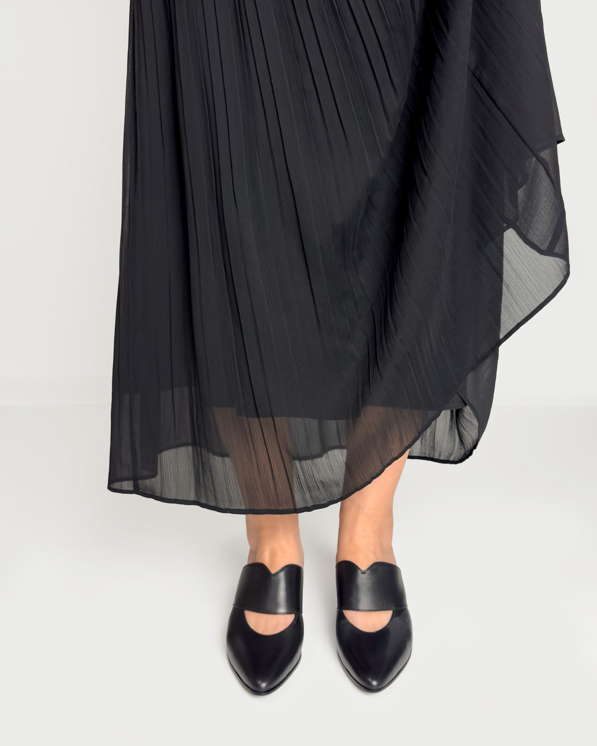 Woman wearing black leather kitten heel mules in Australia