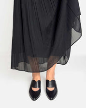 model wearing black mules with kitten heels paring with skirt