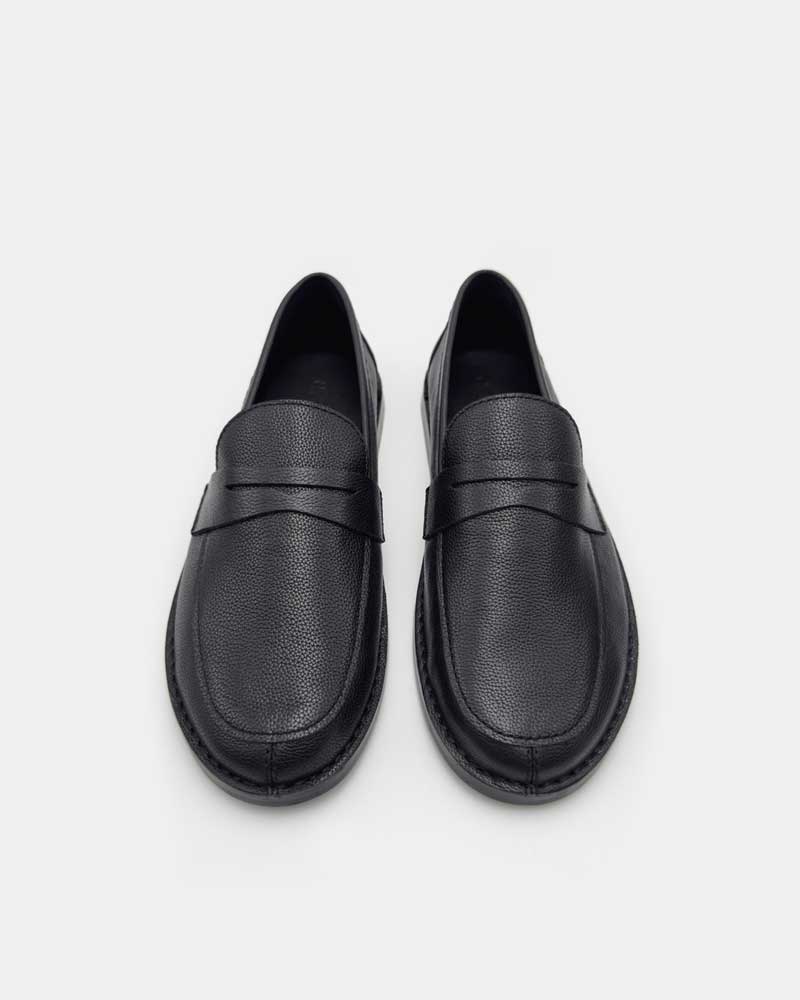 Top view of black penny loafers in leather