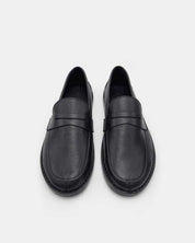 Top view of black penny loafers in leather