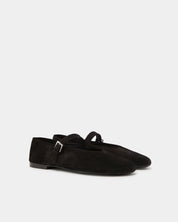Pair of black suede ballet flats with strap