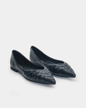 A pair of black leather pointed-toe flats with a woven pattern on the toe, shown on a light gray background.