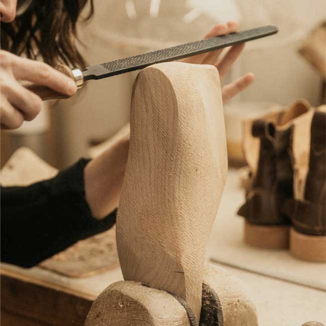 Artisan from ellementa is polishing a shoe last for women's perfect fit 