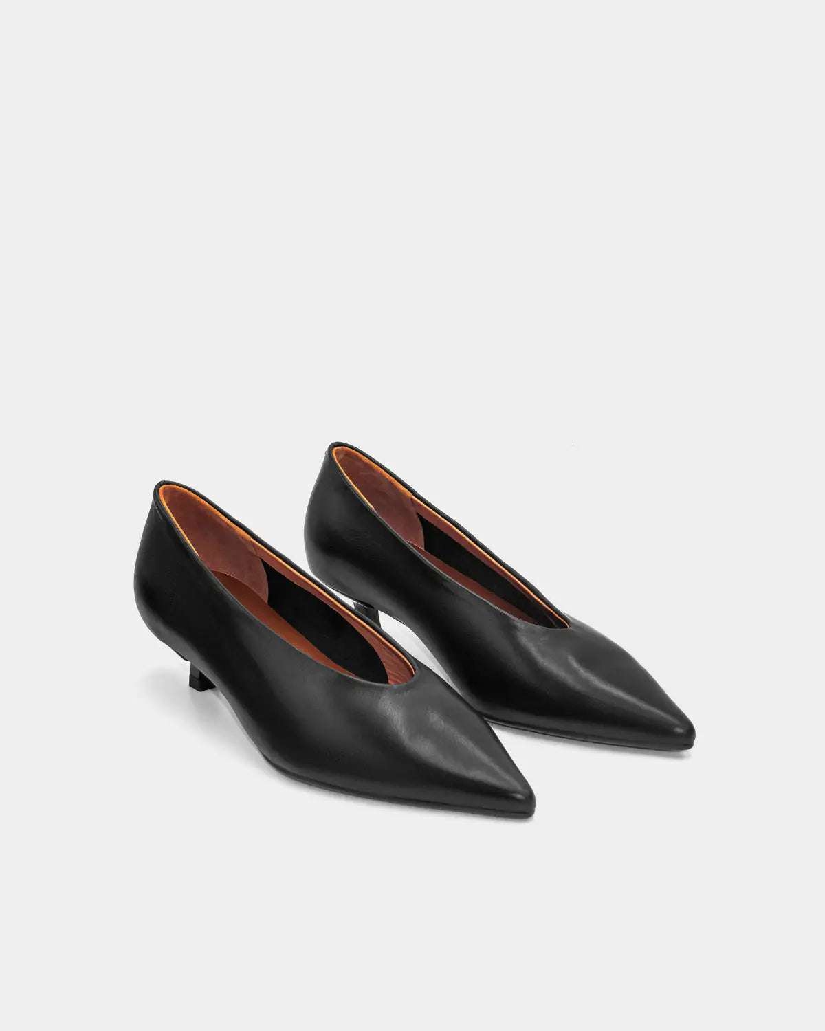 Polished black leather kitten heels with clean lines and a low-profile heel, ideal for professional settings and formal occasions.