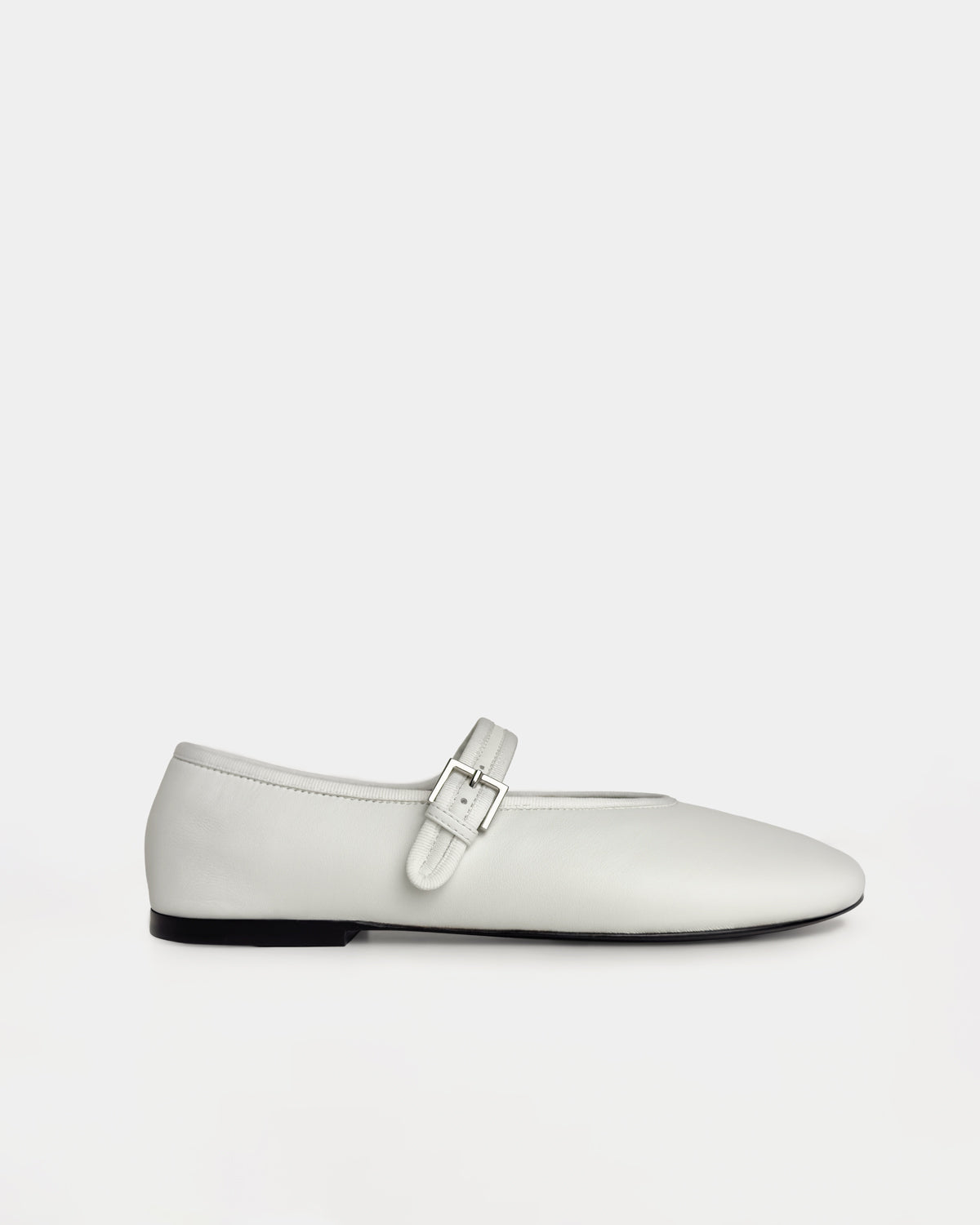 A white ballet flat shoe with a silver buckle strap, shown in a side profile against a solid light gray background.
