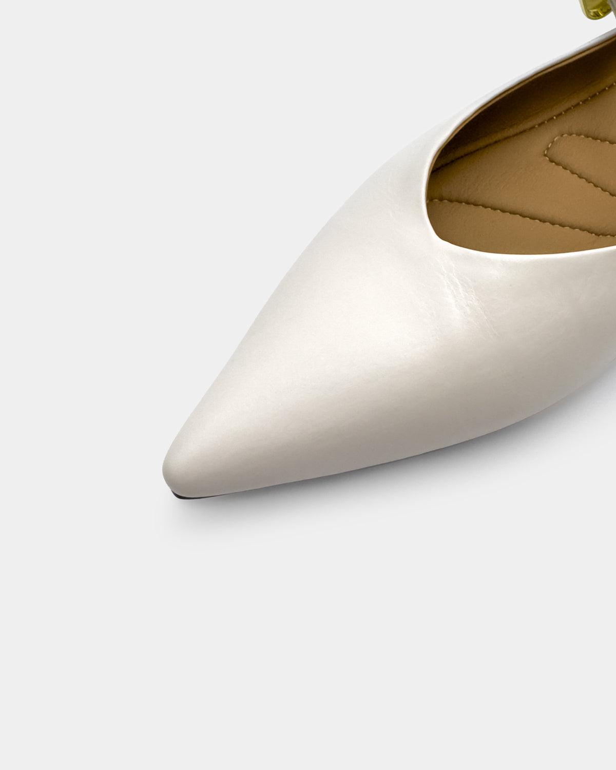 White leather Mary Jane flats with cushioned footbed and pointed toe