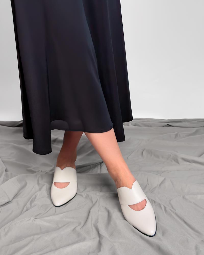 model styling kitten heel white mules with skirt
