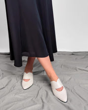 model styling kitten heel white mules with skirt