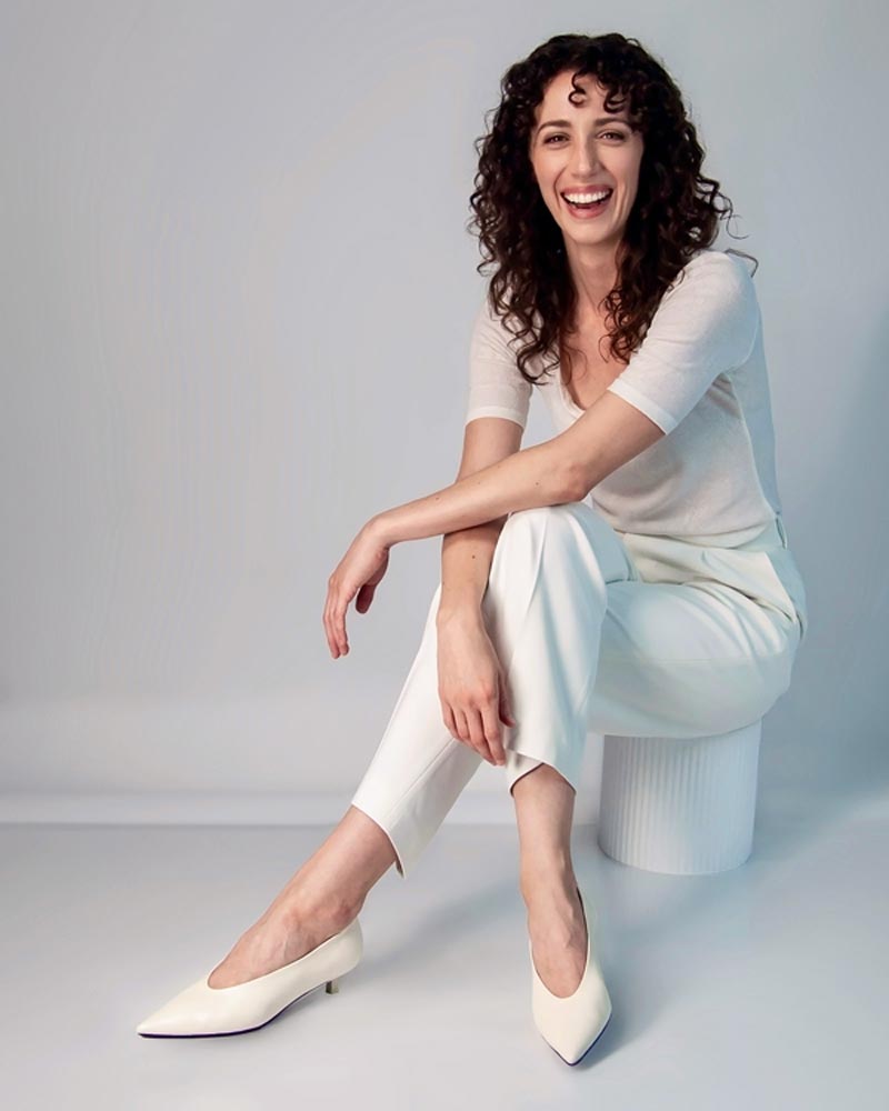 Model wearing white leather kitten heels with white outfits