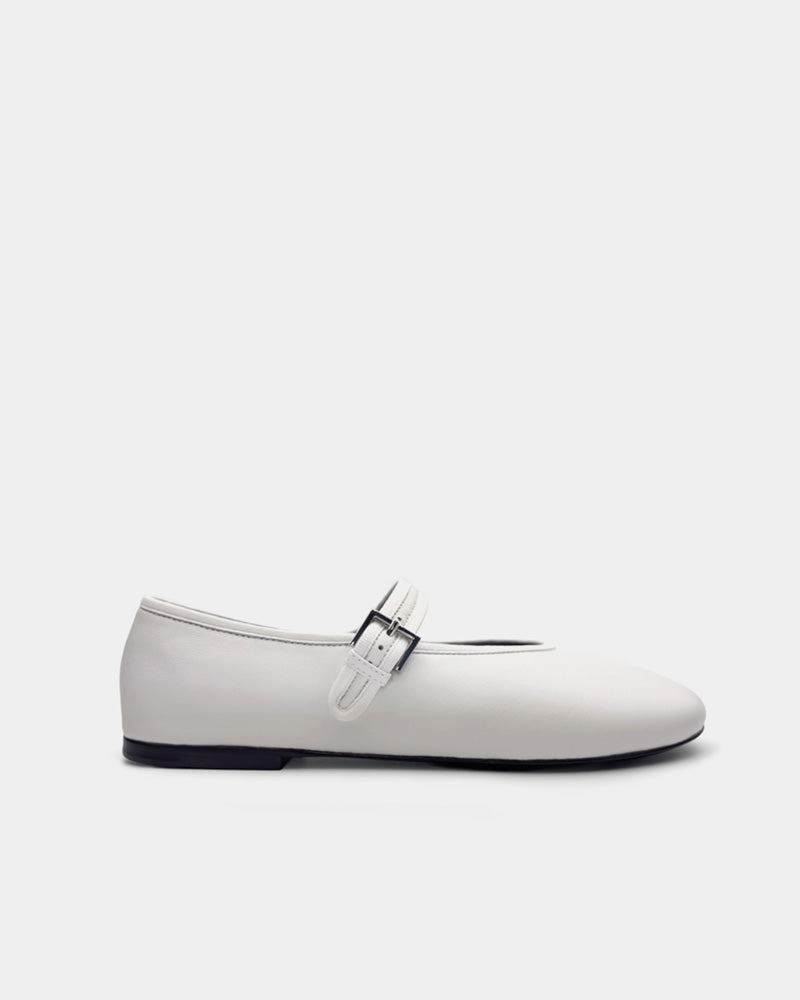 Side view of white ballet flats with strap