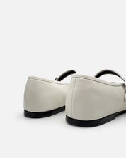 back view of white ballet flats in leather