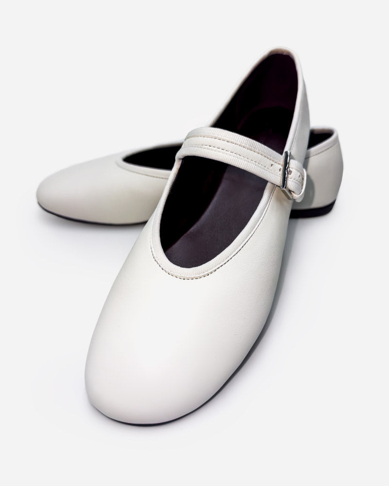 pair of white leather ballet flats—minimal slip-on design