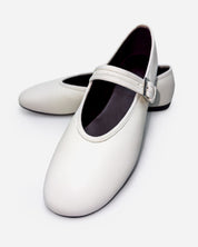 pair of white leather ballet flats—minimal slip-on design