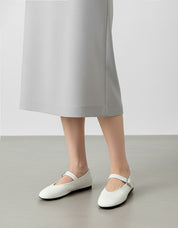white leather ballet flats styled for office commute