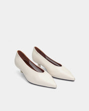 a pair of white kitten heels with leather insole
