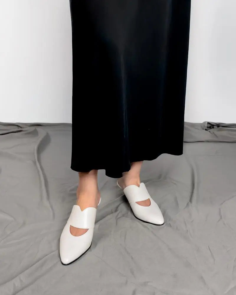 model wearing white mules kitten heel style with dress