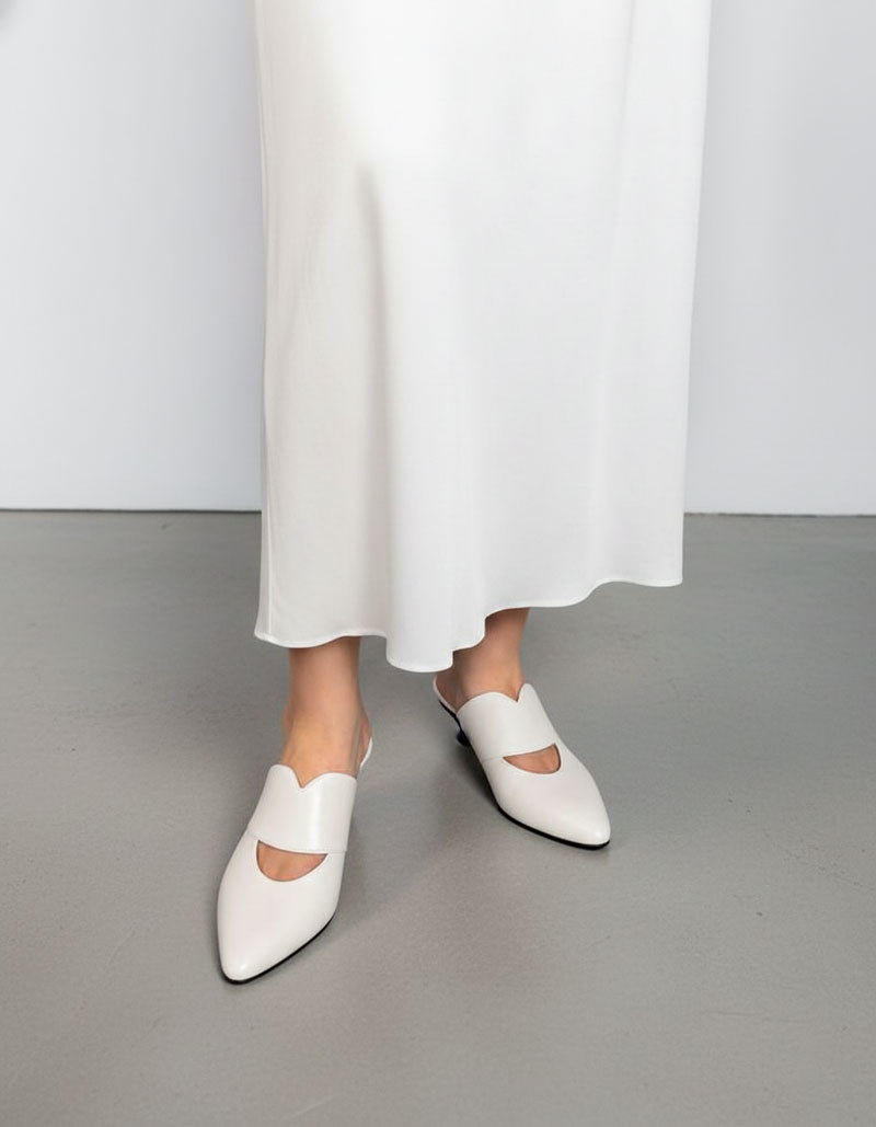 model wearing white mules kitten heel style with dress