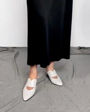 model wearing white mules kitten heel style with dress
