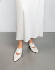 model wearing white mules kitten heel style with dress