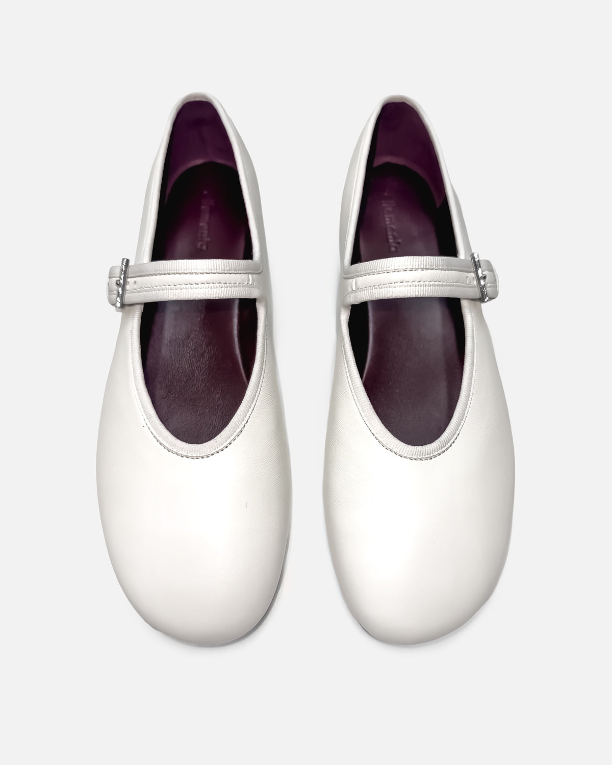 white ballet flats with cushioned leather footbed for all-day comfort