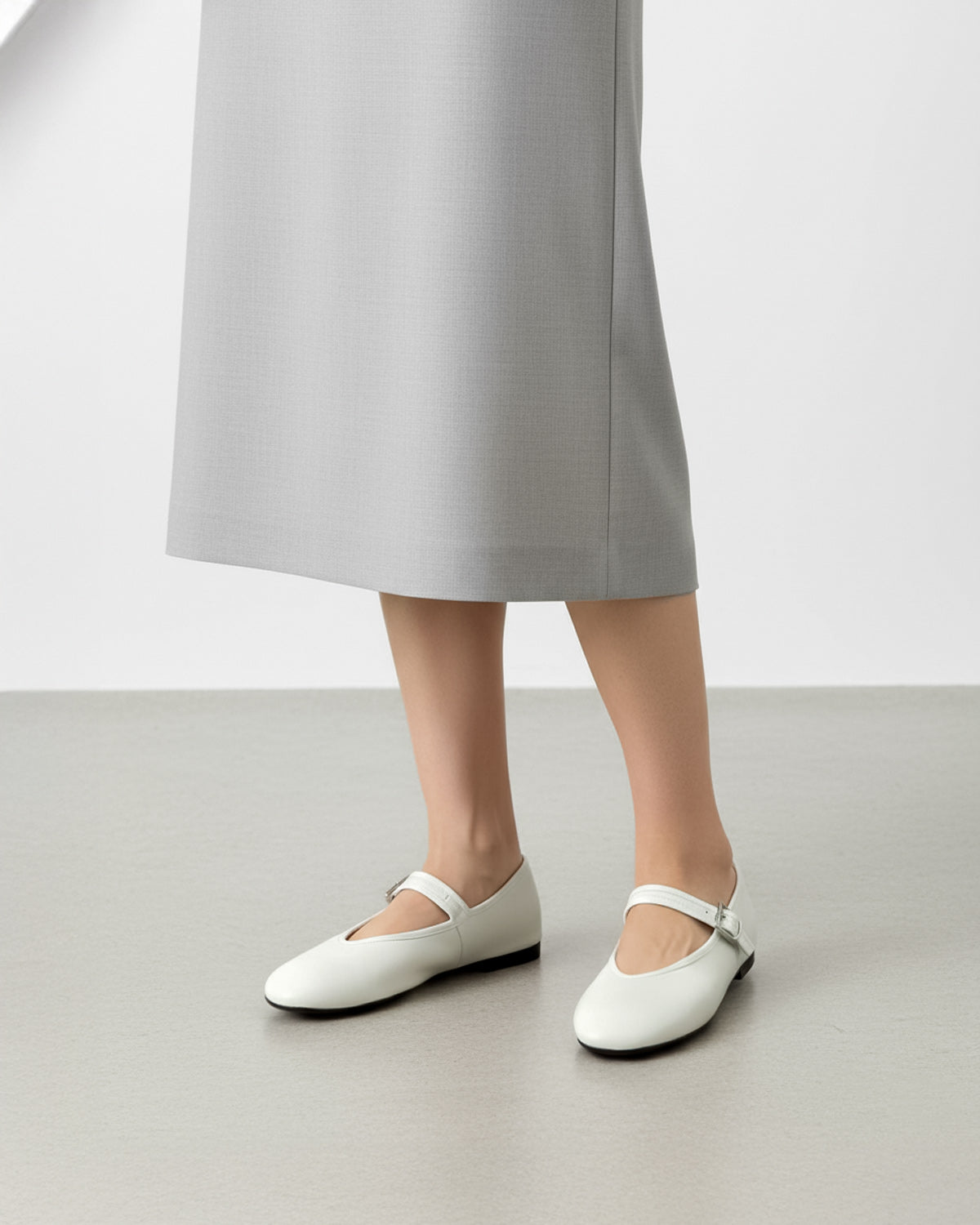 Ladies white leather ballet flats styled for office commute 